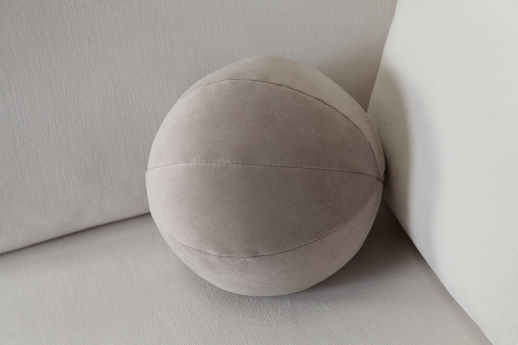 Set of (2) 10" Round Accent Pillows in Mink Tan Velvet by Diamond Sofa - styled in a staged room by Center Stage Home Design