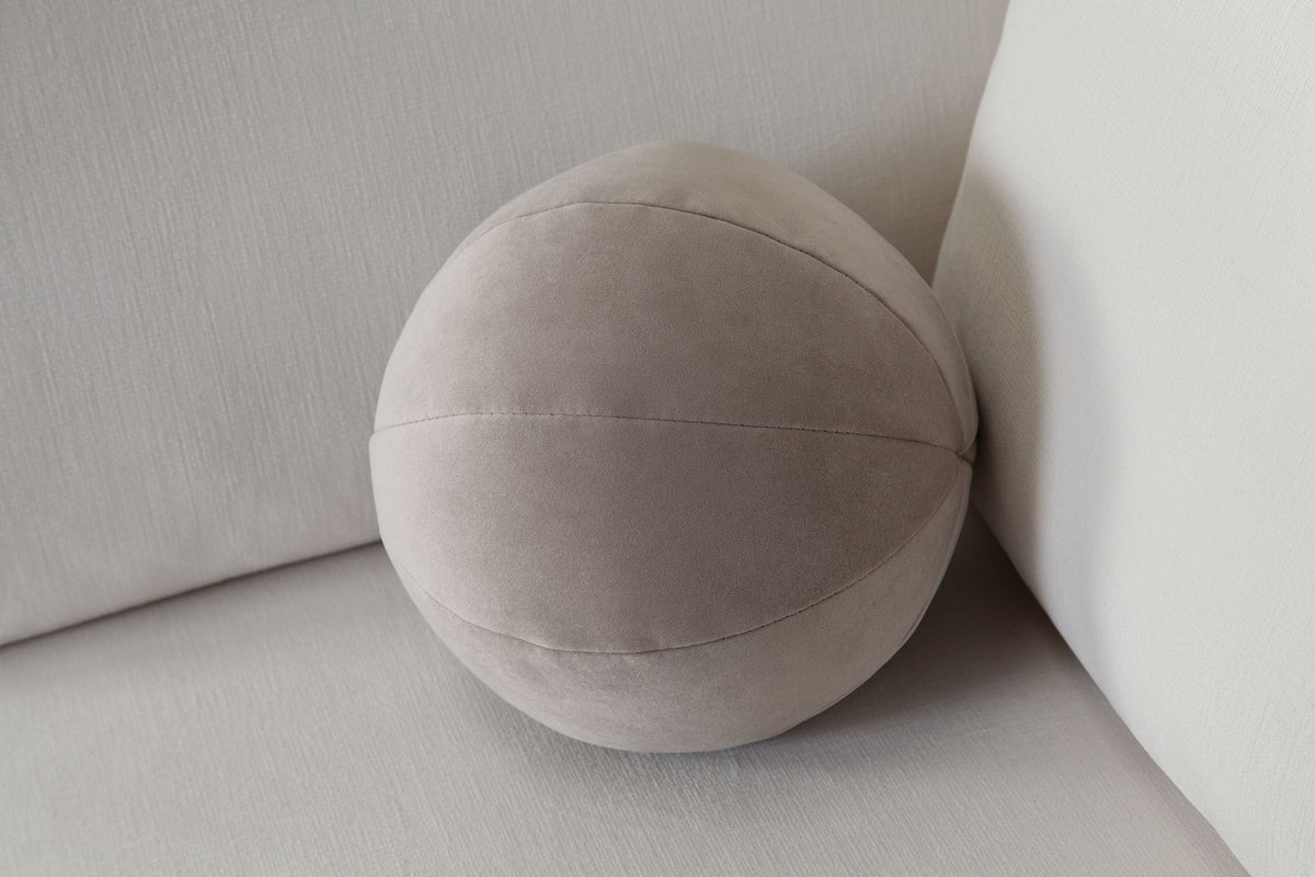 Set of (2) 10" Round Accent Pillows in Mink Tan Velvet by Diamond Sofa - styled in a staged room by Center Stage Home Design