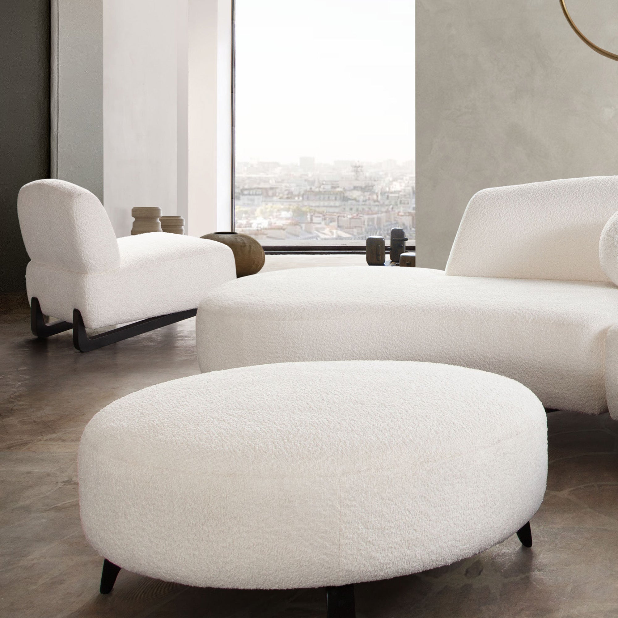 Vesper Round Ottoman in Faux White Shearling w/ Black Wood Leg Base by Diamond Sofa - styled in a staged room by Center Stage Home Design