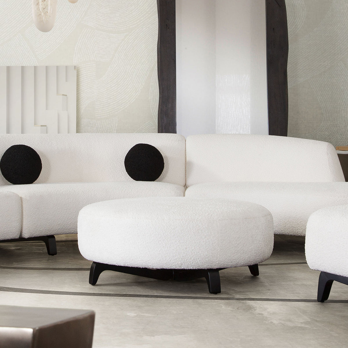 Vesper Round Ottoman in Faux White Shearling w/ Black Wood Leg Base by Diamond Sofa - styled in a staged room by Center Stage Home Design